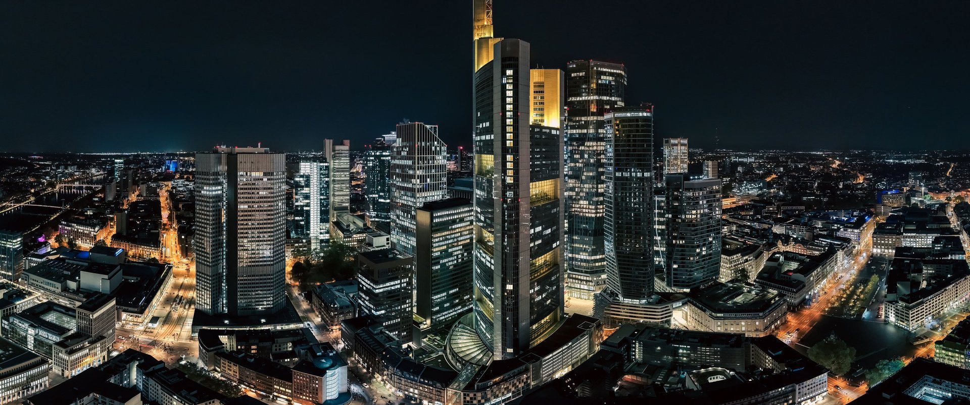 Modern high-rise building with glass facade at night