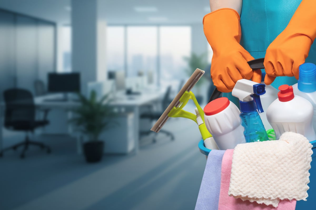 Office cleaning services. A team member prepares cleaning supplies while readying to service an office space.